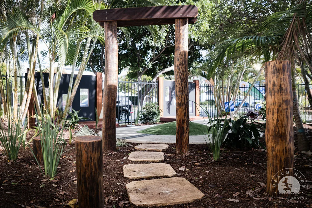 A stepping-stone path between timber posts and palms in the Cabarita yard