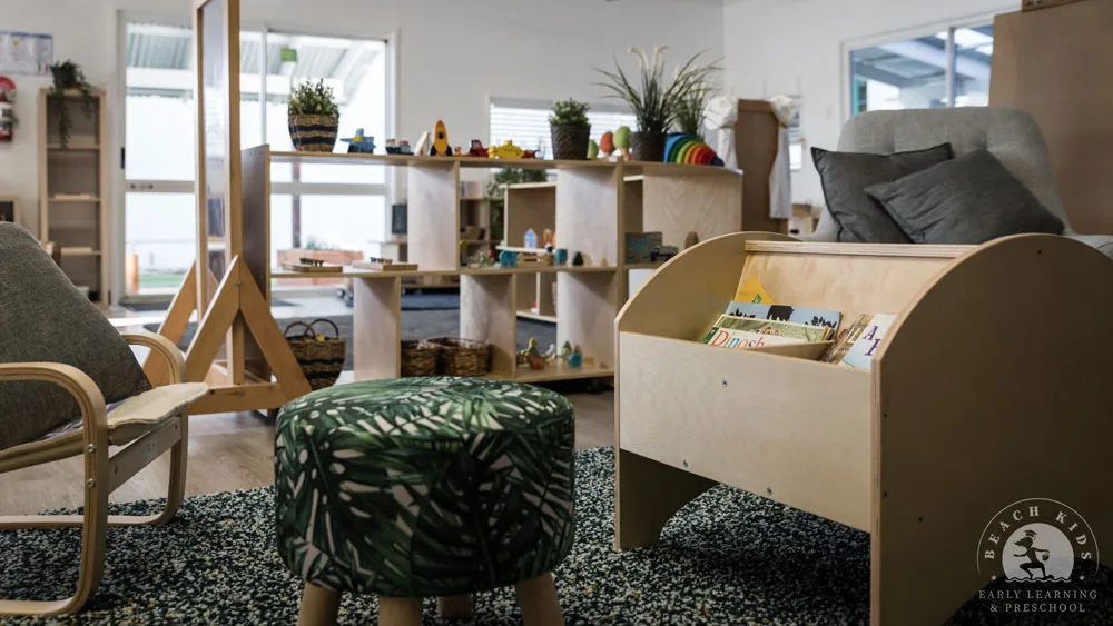 A quiet reading corner with an armchair and book display at Beach Kids Cabarita