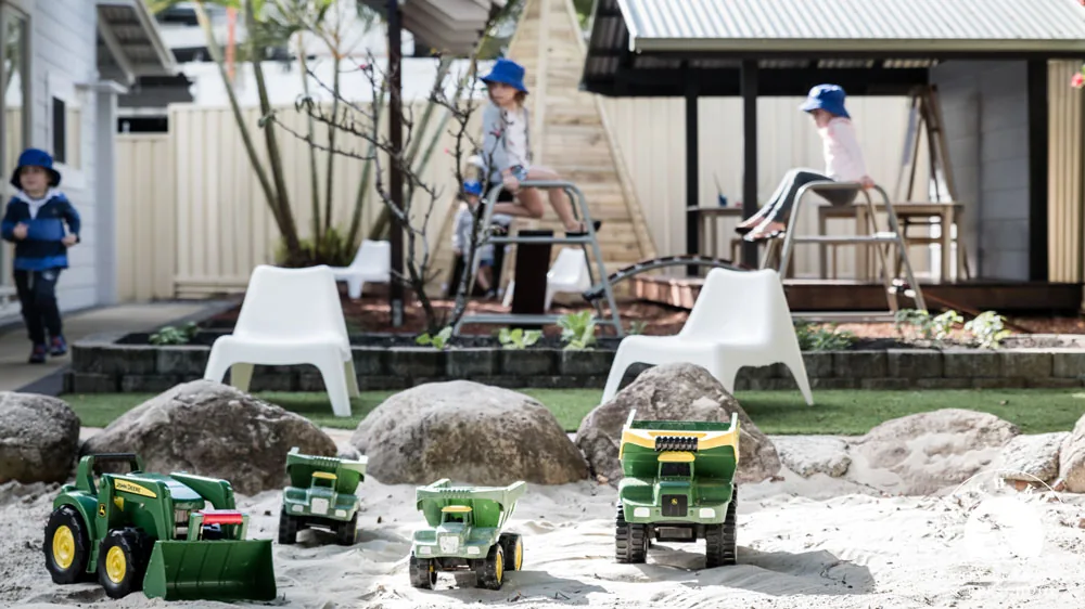 Children playing in the sandpit and yard at Beach Kids Cabarita